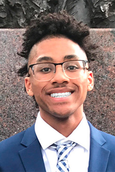 Headshot of Joey Arnold, a young Black man, wearing glasses, a blue suit jacket, and a blue and white plaid tie. He is identified as the 2022 IEEE Scholarship Plus Initiative Scholar, Class of 2022, M.Eng., Electrical & Electronics Engineering, Drexel University College of Engineering. The logo at top right says IEEE PES, IEEE Power & Energy Society Scholarship Plus Initiative, Preping the Next Generation of Power and Energy Engineers.